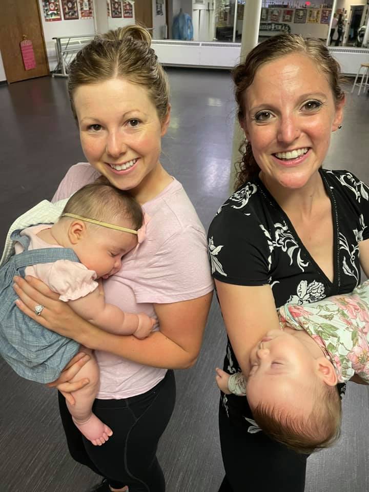 Rae & Valerie holding their sleeping babies after Baby Ballroom class